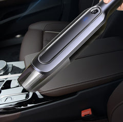 Portable car vacuum cleaner cleaning center console, sleek design with LED indicator for auto interior detailing