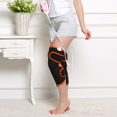 Black and orange knee massager with remote control for home muscle therapy and relaxation