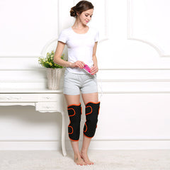 Woman using black and orange knee massager with remote control at home