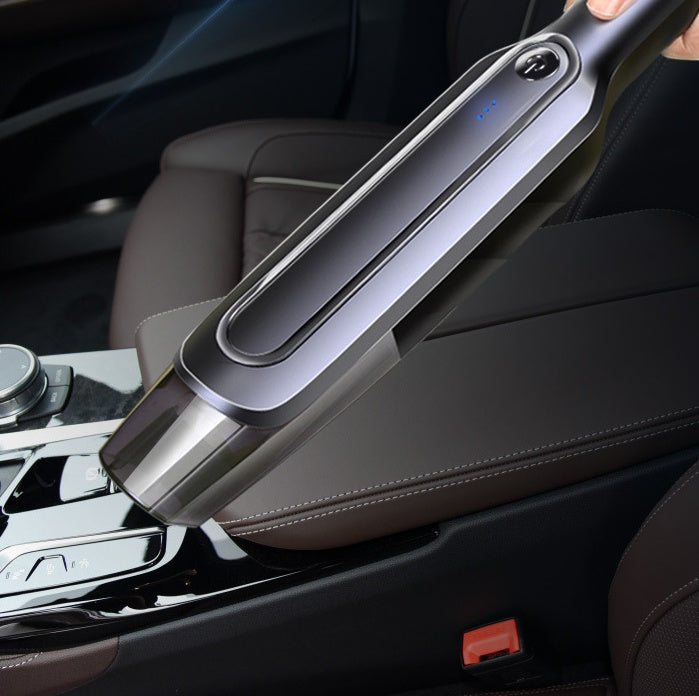Portable car vacuum cleaner cleaning center console, sleek design with LED indicator for auto interior detailing