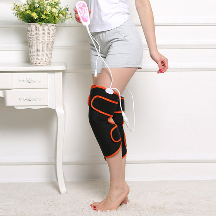 Black and orange knee massager with remote control for home muscle therapy and relaxation