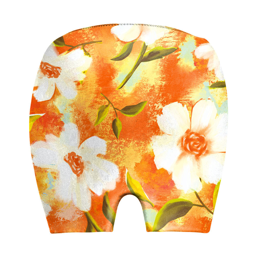 Floral print baby bloomers with white flowers and orange background, soft cotton design for infants